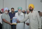 Speaker S. Sandhwan distributed documents regarding ownership rights to the people living within the red line of 2 villages